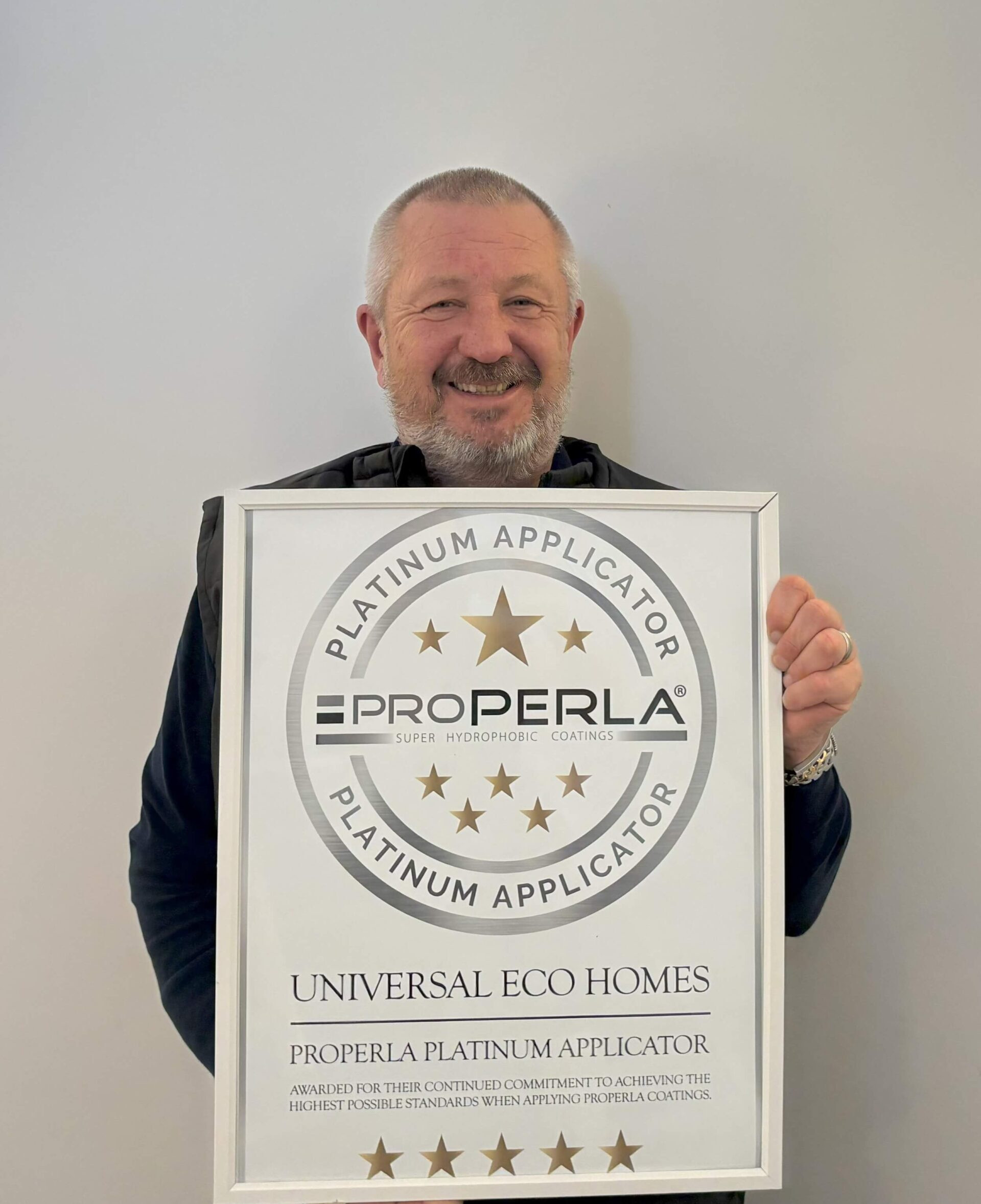 Chris Law holding the complete framed Platinum Applicator placard